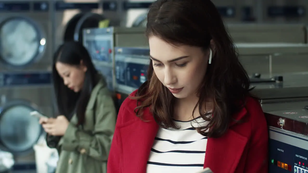 Young Pretty And Stylish Girl Sitting In Laundry Service Room