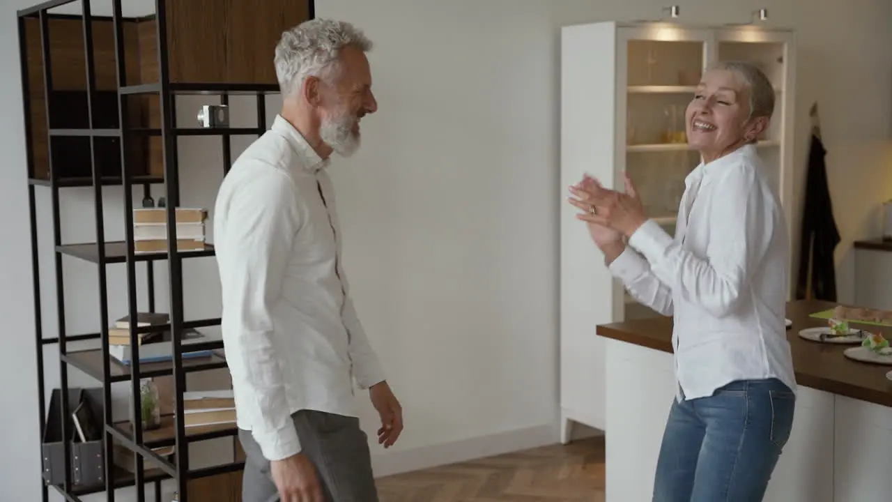 Happy Senior Couple Having Fun And Dancing At Home