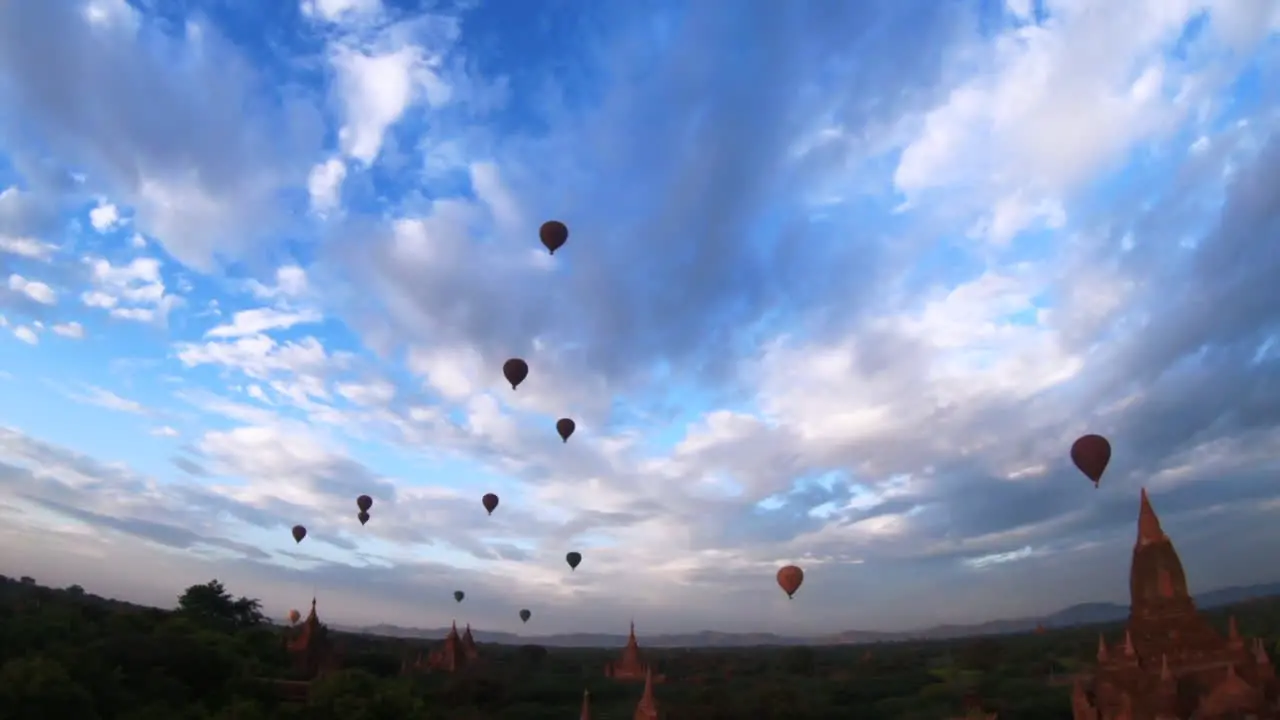 bagan burma myanmar hot air balloons temples pagodas panning wide angle shot