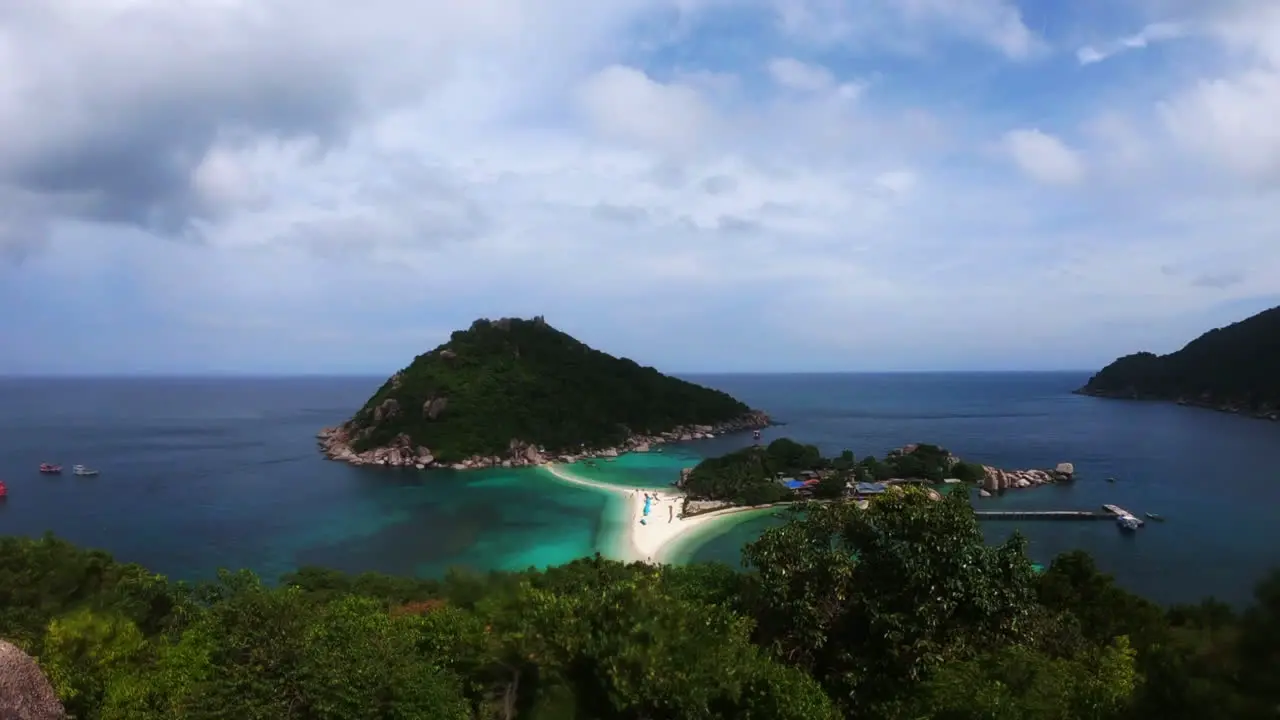 left to right panning shot of Koh Nang Yuan Island in Thailand Asia showing the white sand double beach sandbar and the clear blue waters below among the jungle filmed in 60fps 4K downscaled to 1080p