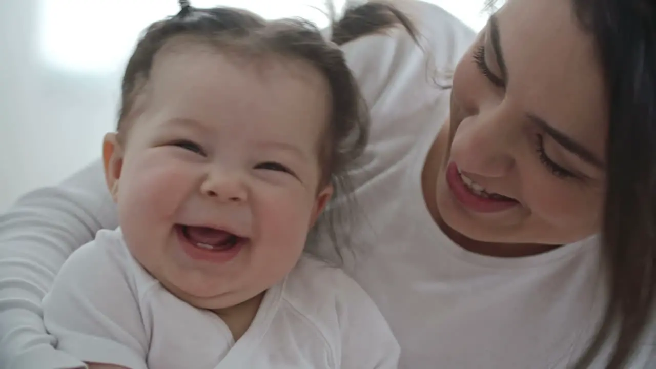 Happy Mother Hugging Her Cute Baby Daughter