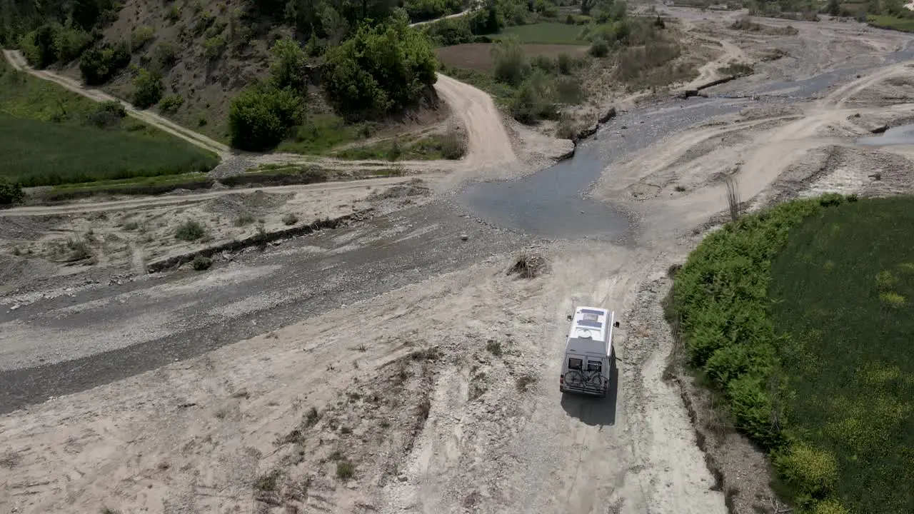 Camper driving off road  adventure and exploration of dry river banks