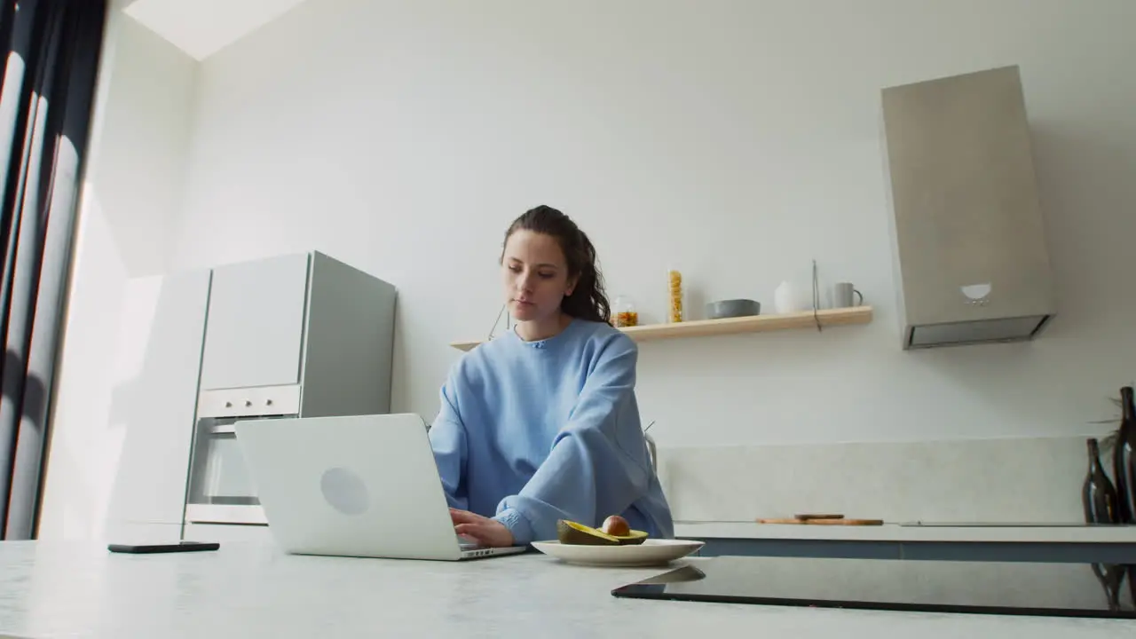 Young Woman Working Working In The Kitchen At Home