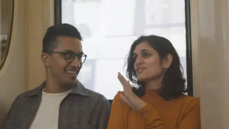 Handheld Shot of Friends Talking On a Train