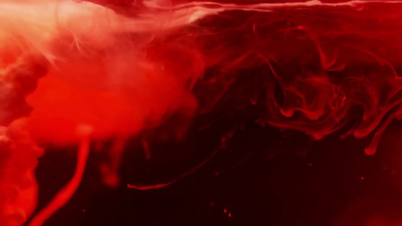 Red ink swirling in water