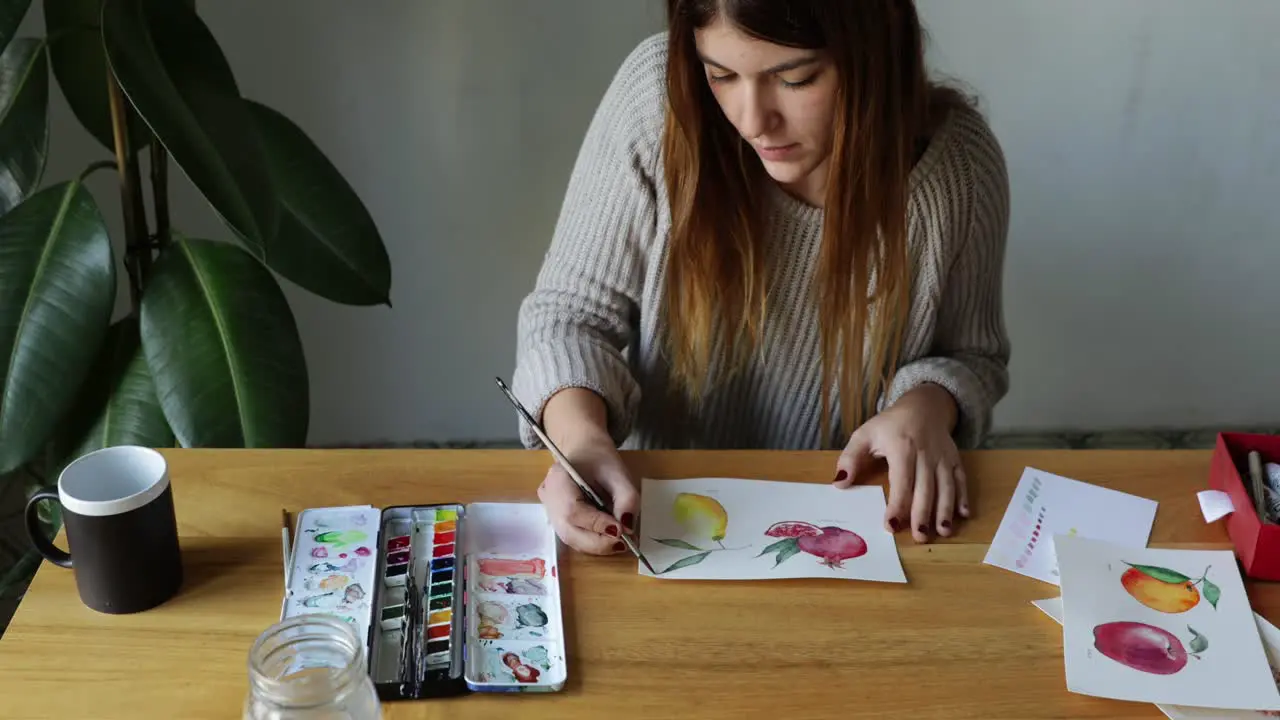 Young girl painting watercolor drawings