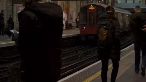 Commuters Waiting For Train On London Train Station Platform 