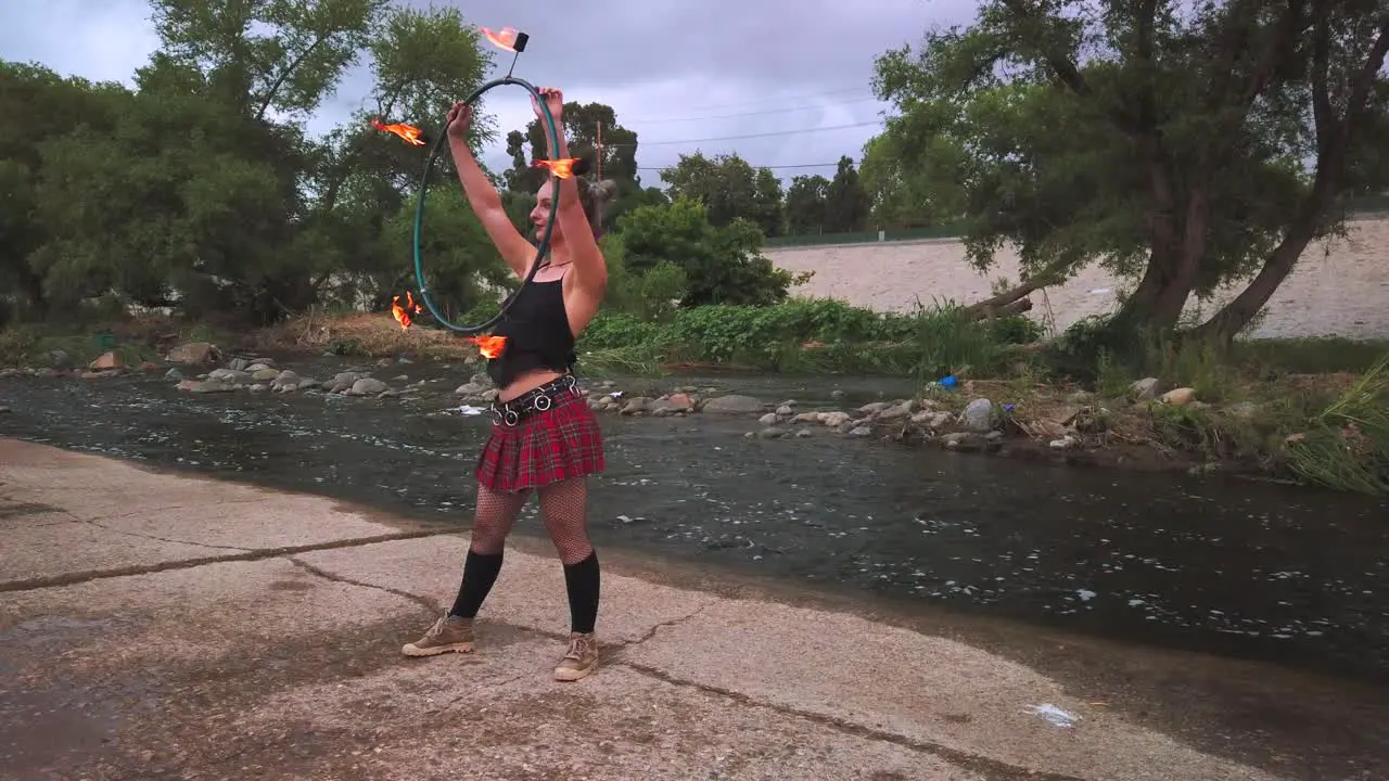 Static shot young female fire performer that was entertaining crown at Los Angeles River