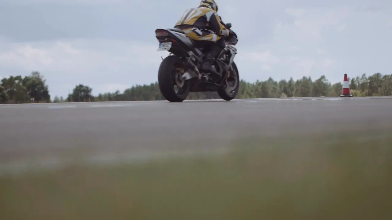 Low angle shot of a sports bike racing on an asphalt track in the Moto show of Poland