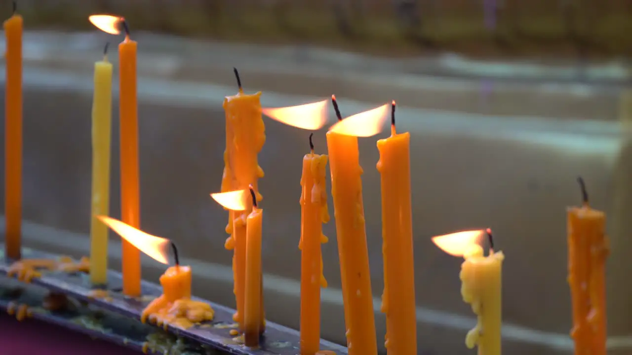 during candles with dripping wax at Doi suthep temple in Thailand