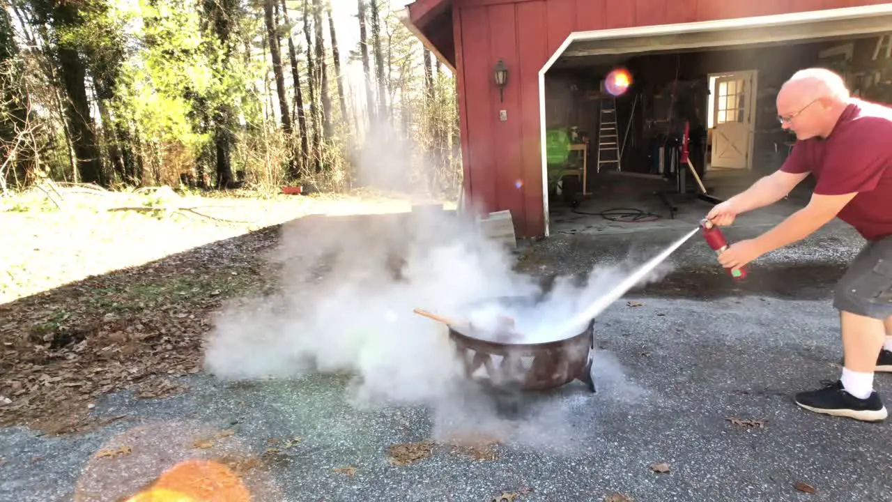 Man rushing to put out fire with fire extinguish