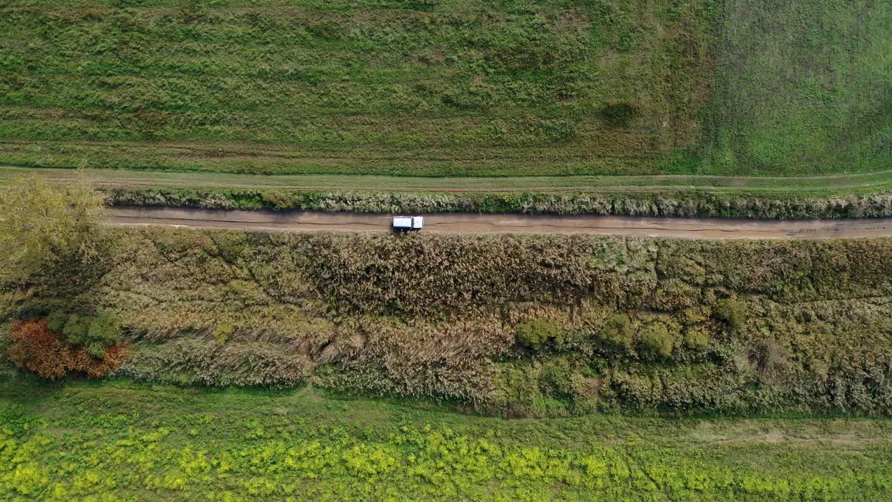 Steady drone shot of a trick driving dirt road in hungary