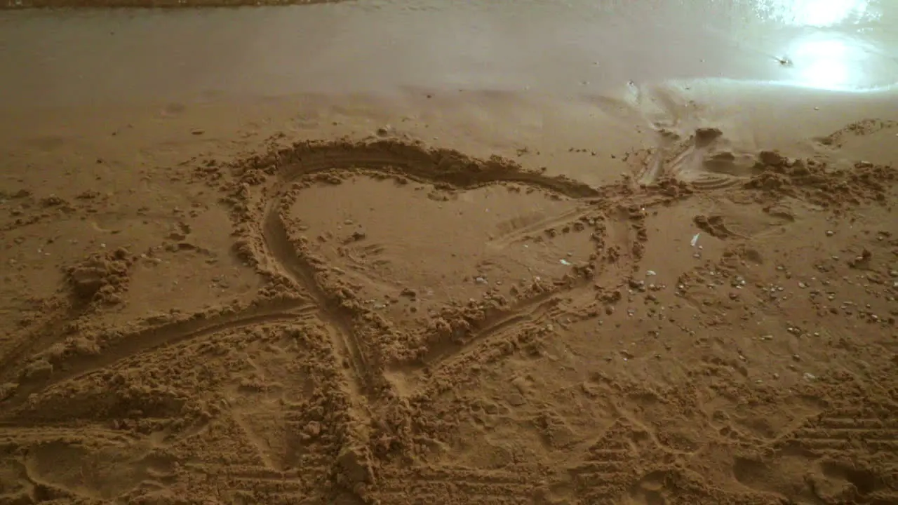 Panning from heart symbol on sand to seascape view Sea beach with heart shape