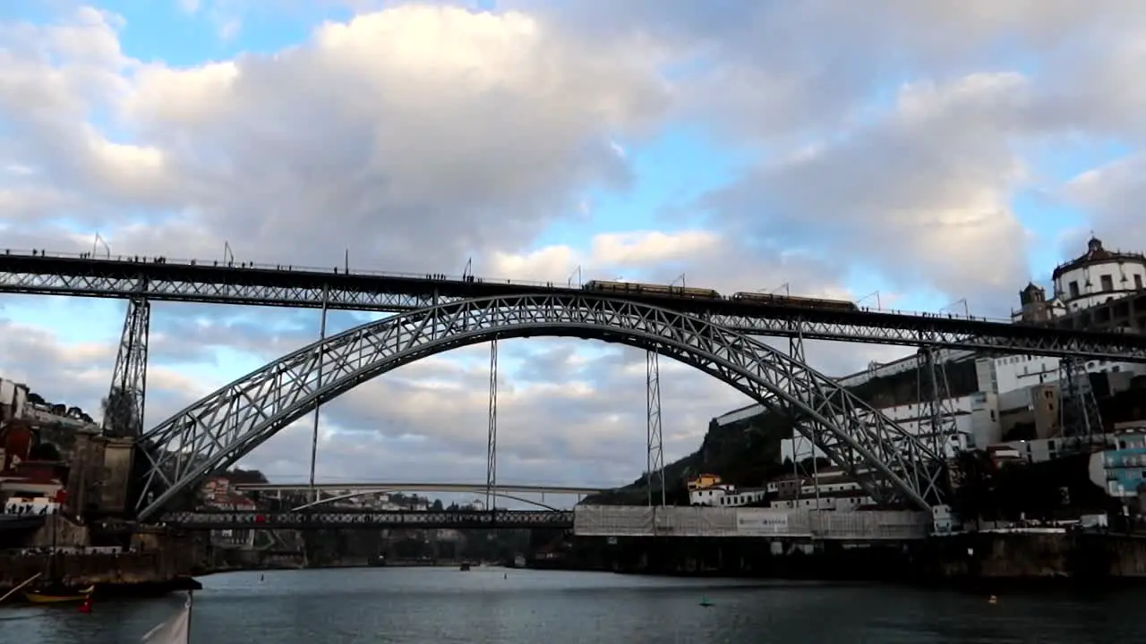 Train on Dom Luis I Bridge as seen from Douro River aboard Rabelo boat