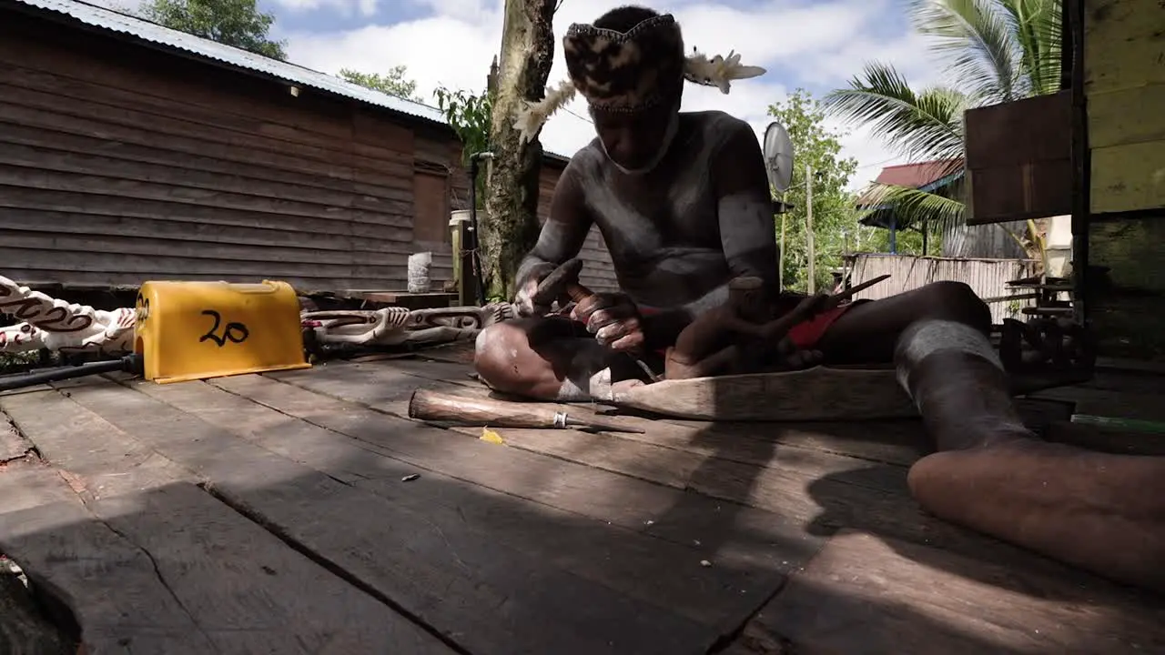 Asmat head hunters and wood carvers in traditional tribal and national customs dress in Papua Indonesia