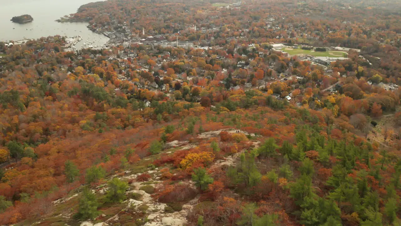 Drone pan up from the top of mount Battie to Camden Maine during autumn