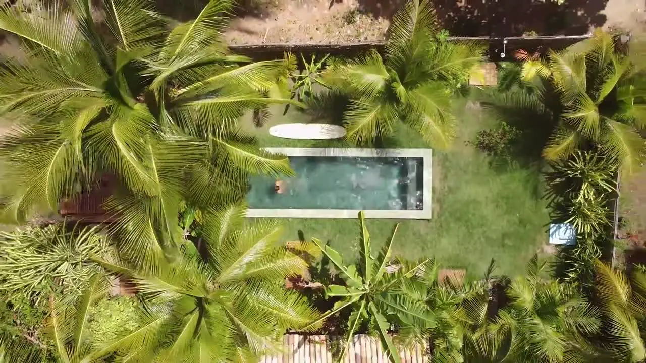 White Caucasian male jump in pool on tropical island  summer vacation