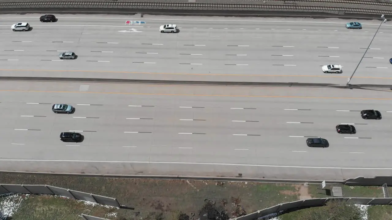 An overhead shot of cars sprinting along a freeway