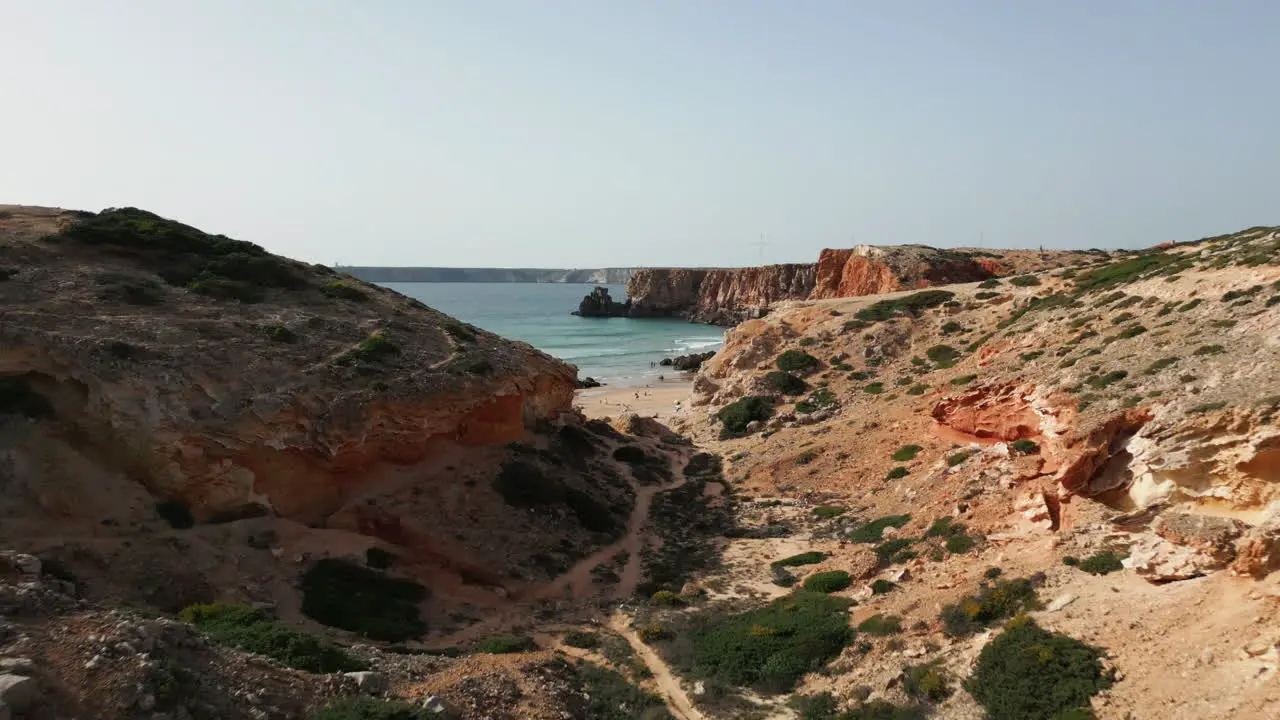 Low flying drone shot revealing beach at Sagres Portugal