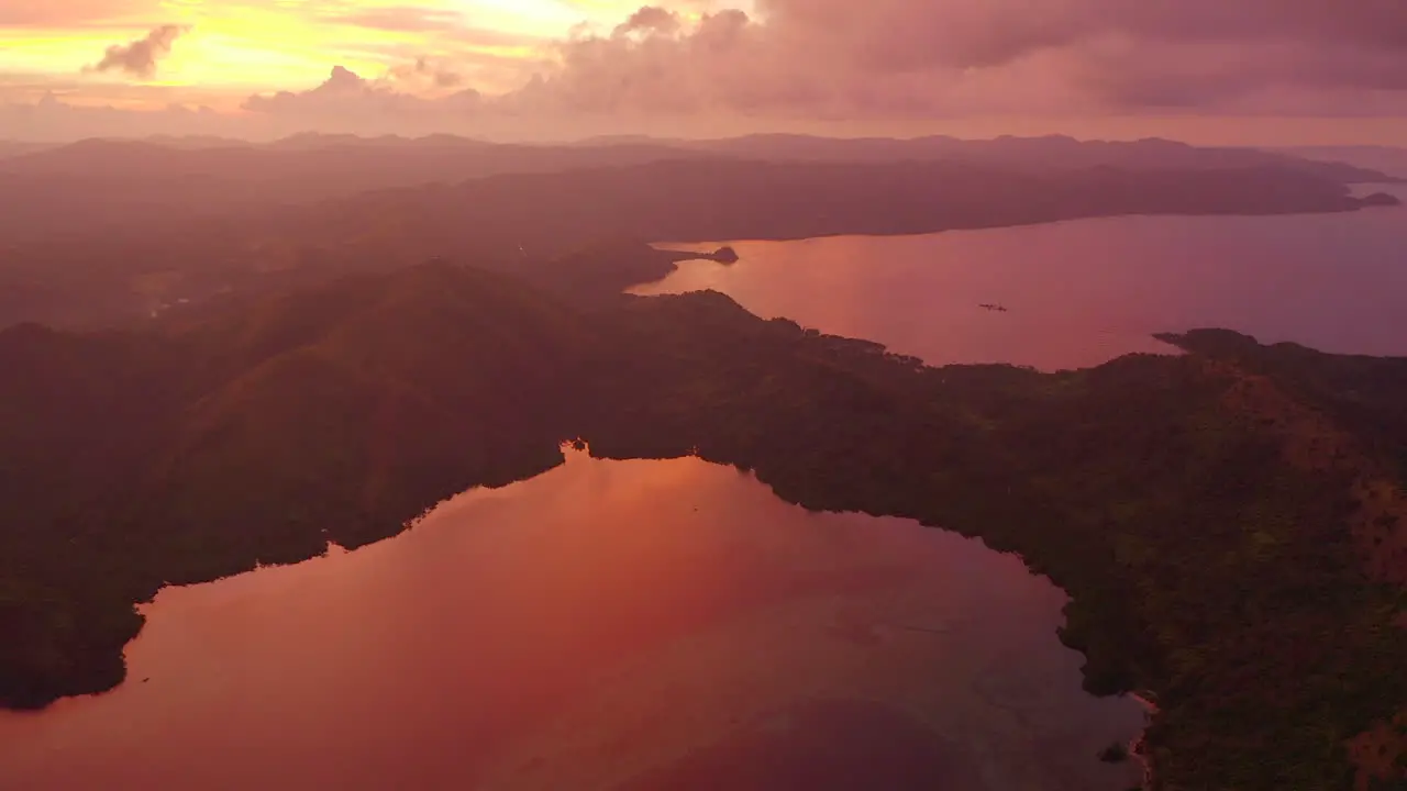 Colorful sunset from a drone over tropical islands in the Philippines at golden hour