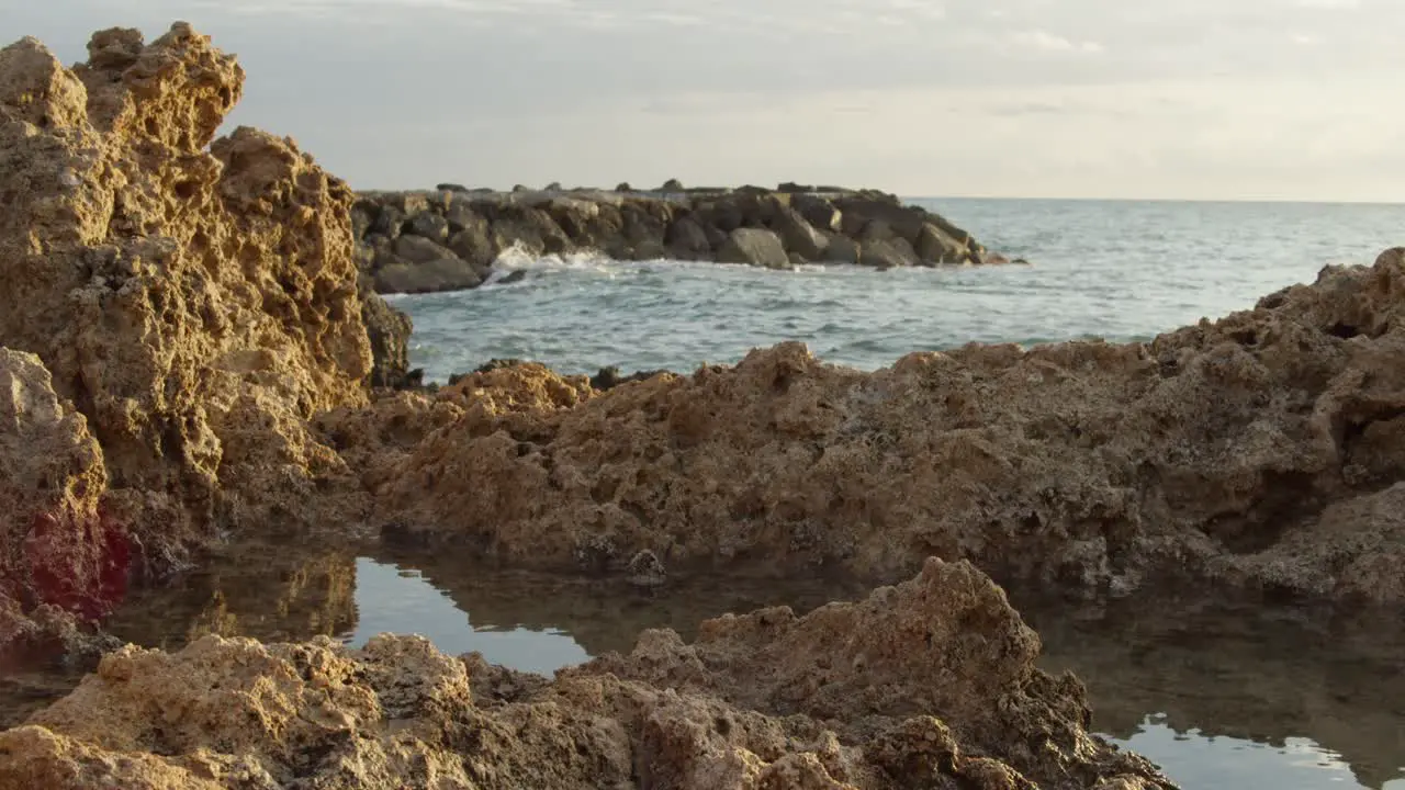 Tranquil Sunset of Mediterranean Sea and Rock Formations in Cyprus Slow Motion Wide