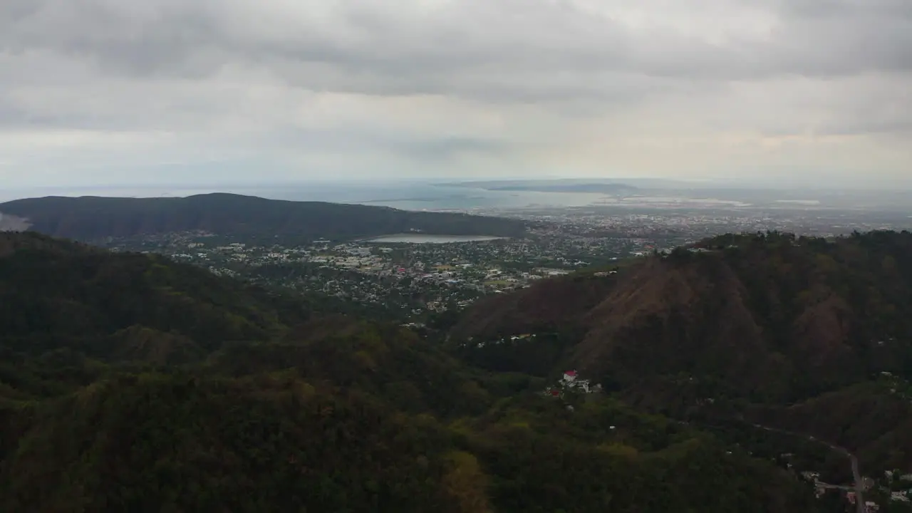 Drone Orbits Left over Mountains and town in Jamaica