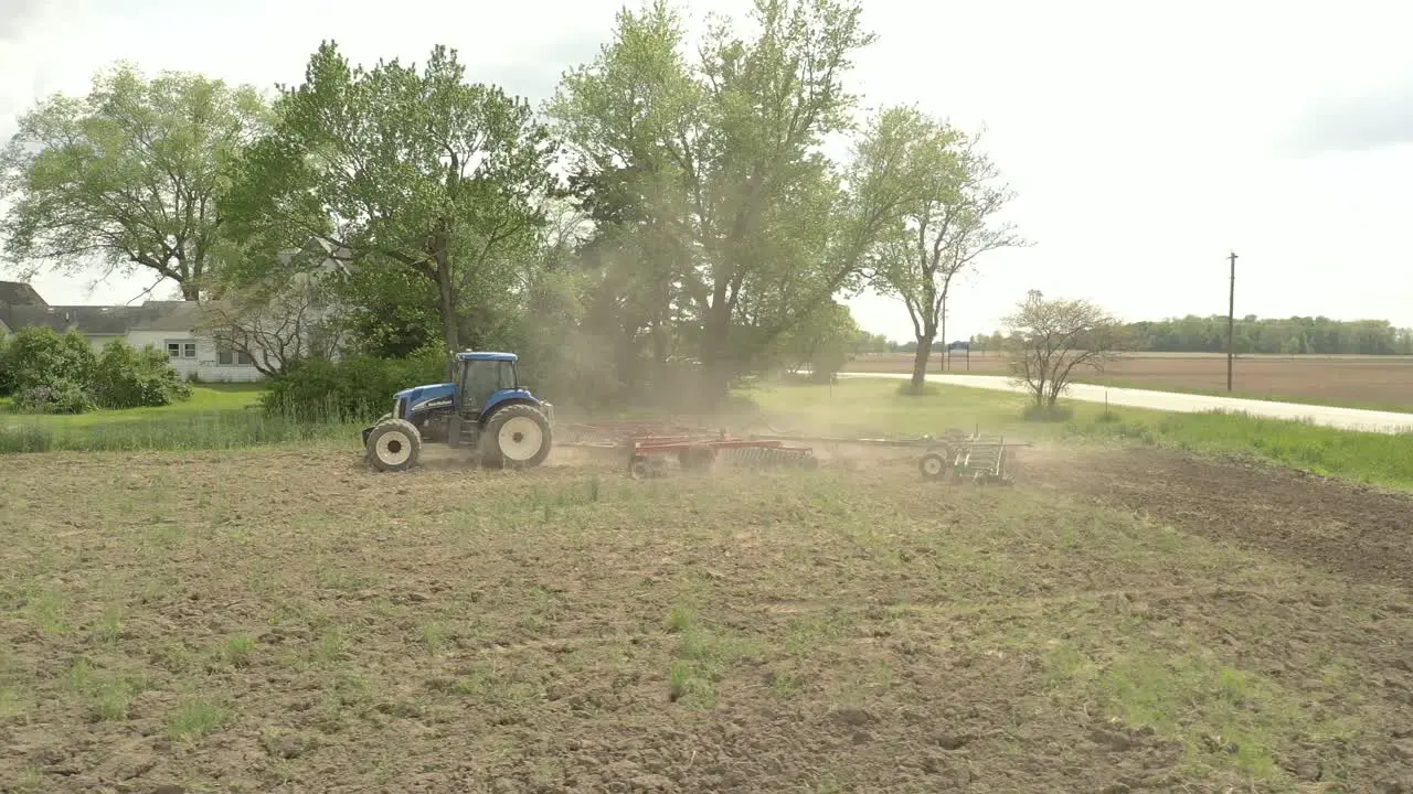 Farmer in tractor cultivating crop in field take 1