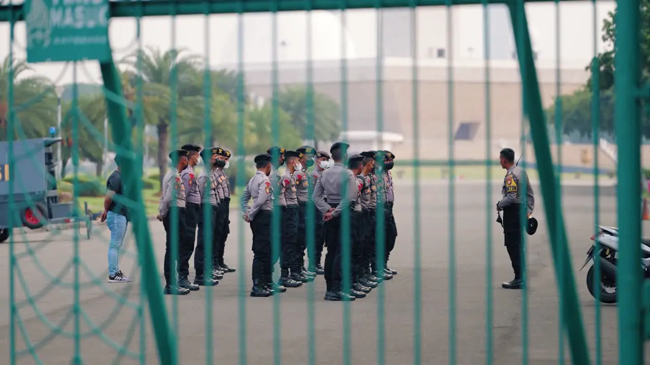 Wide Shot of Indonesian Servicemen Behind Fence