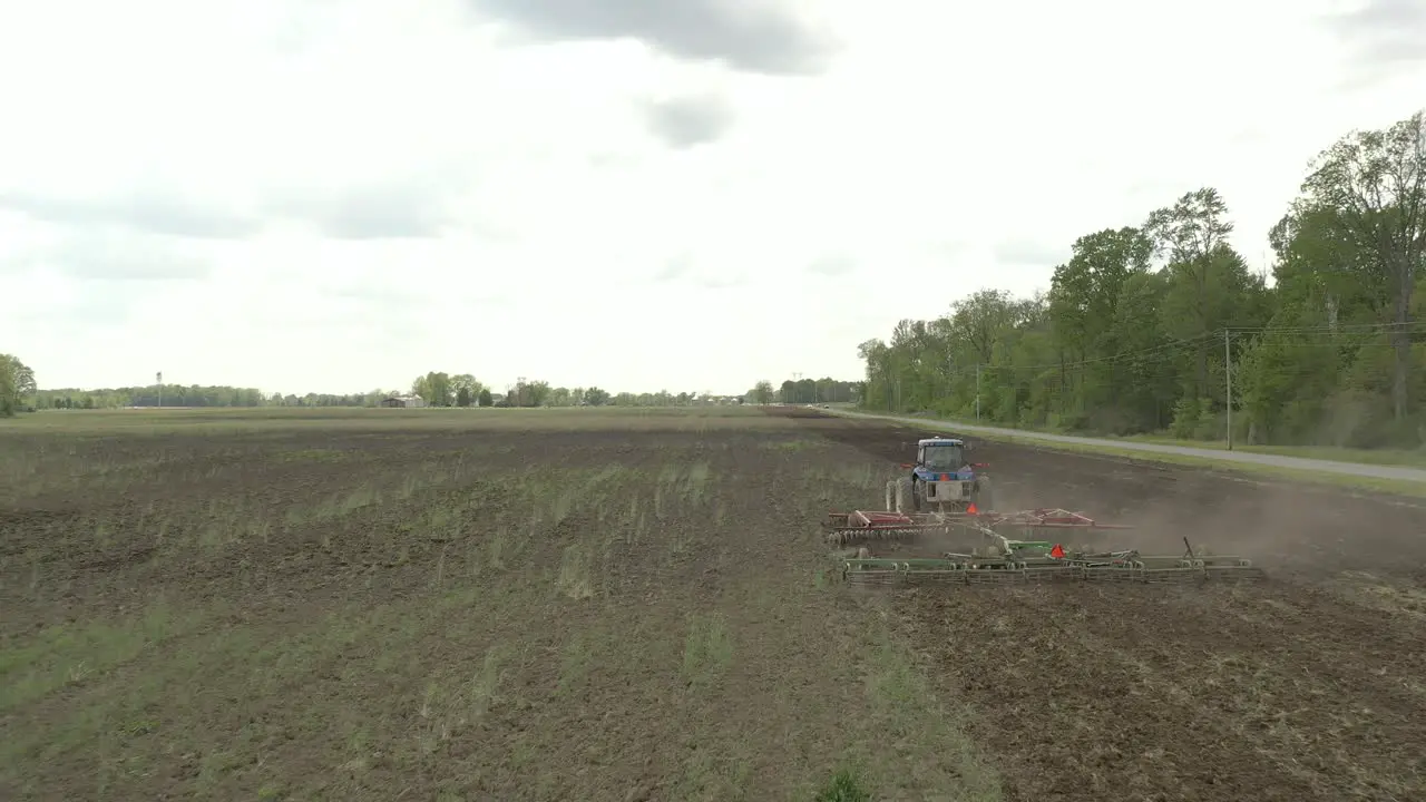 Farmer in tractor cultivating crop in field take 4