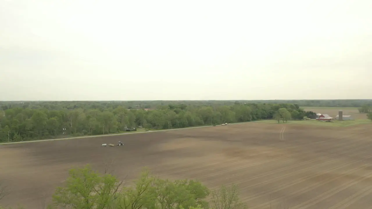 Farmer in tractor cultivating crop in field take 11