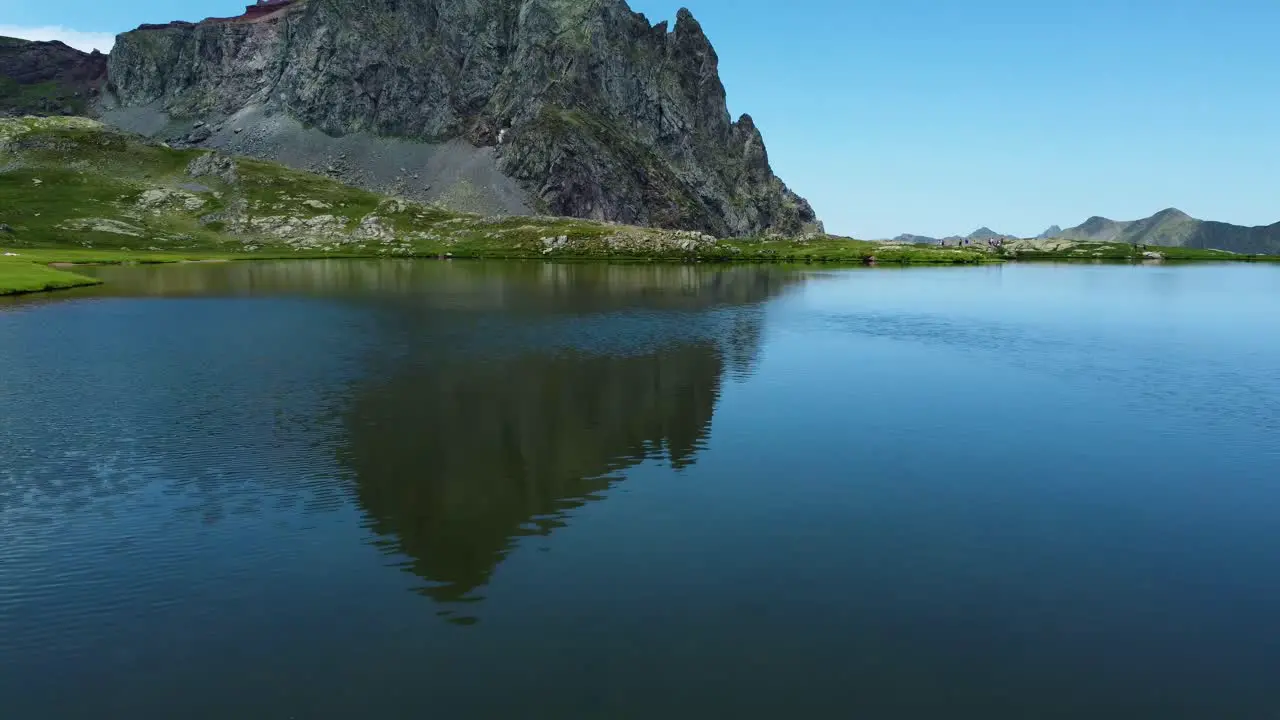 Over-the-water video from a drone above a mountain lake during summer