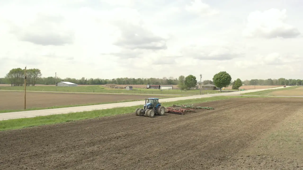 Farmer in tractor cultivating crop in field take 5