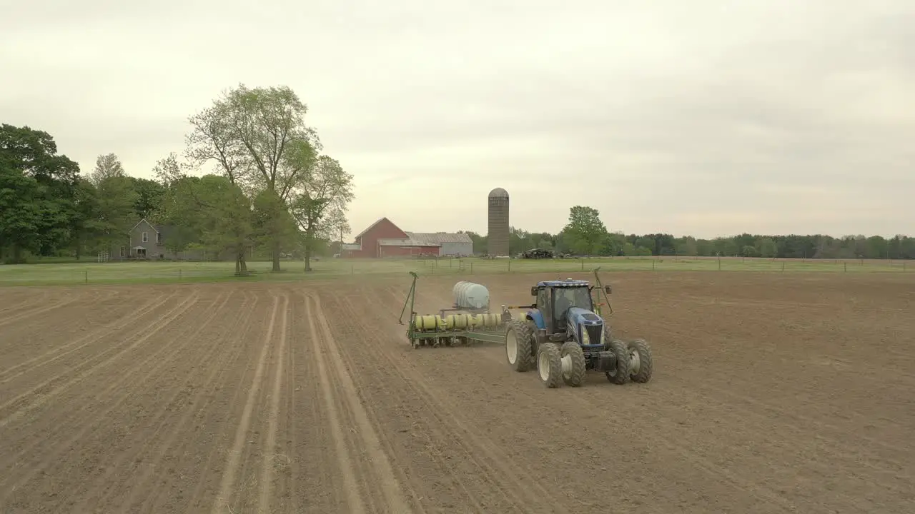 Farmer in tractor cultivating crop in field take 10