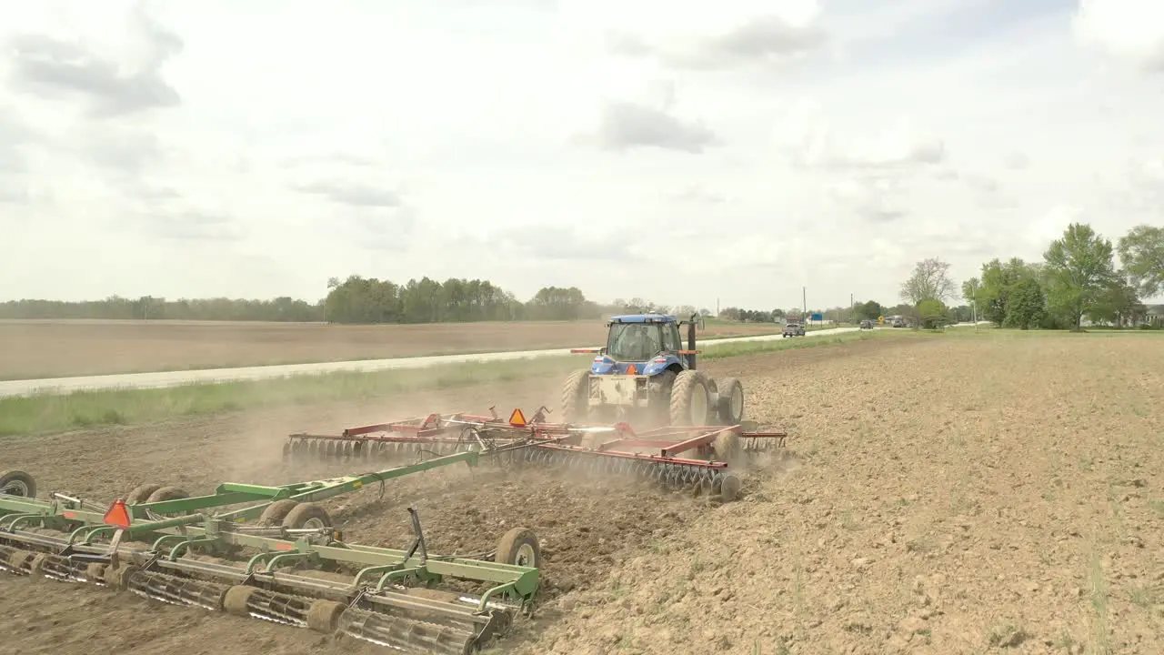 Farmer in tractor cultivating crop in field take 7