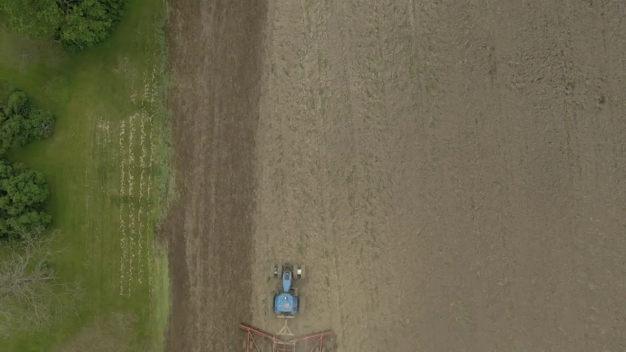 Farmer in tractor cultivating crop in field take 2