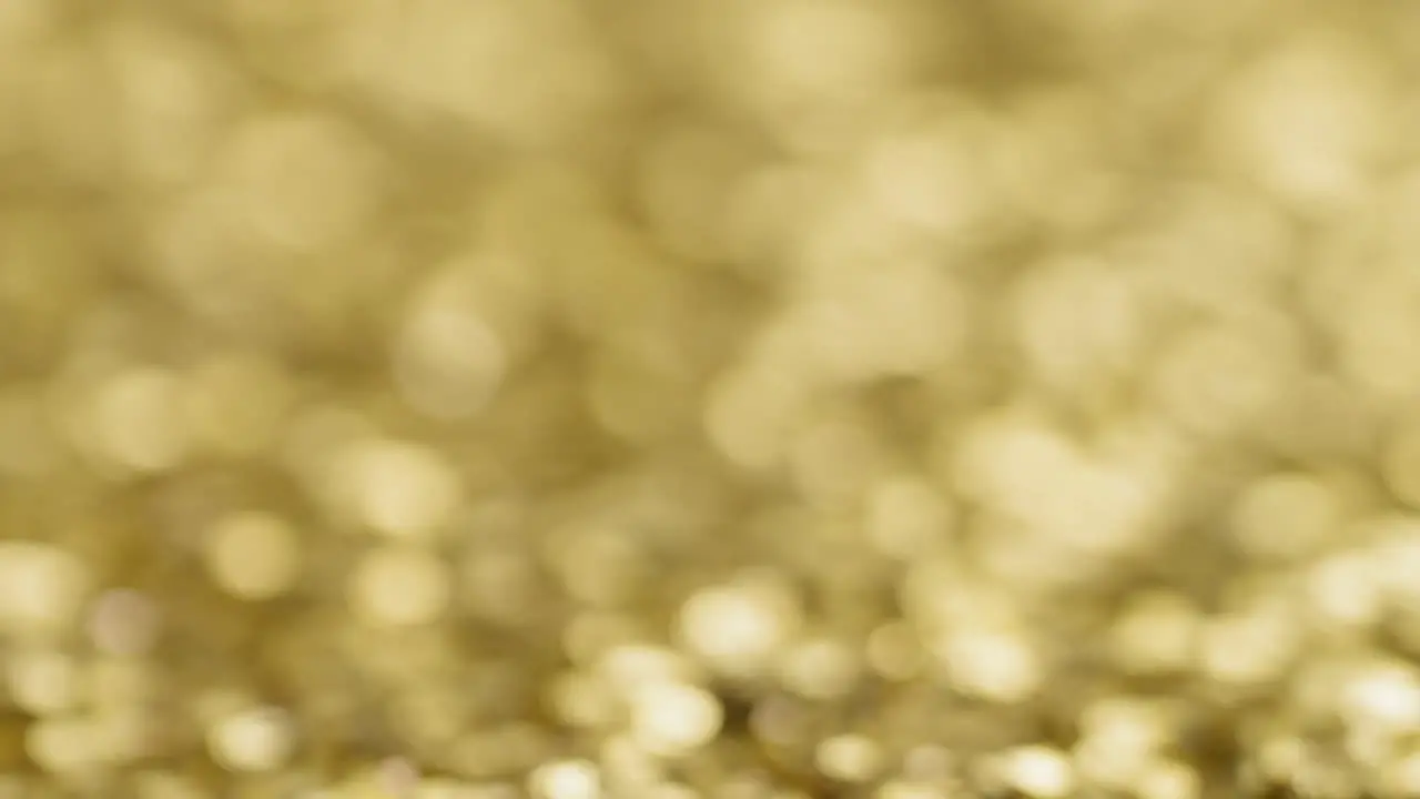 Gold sequins with blurred background establishing background shot