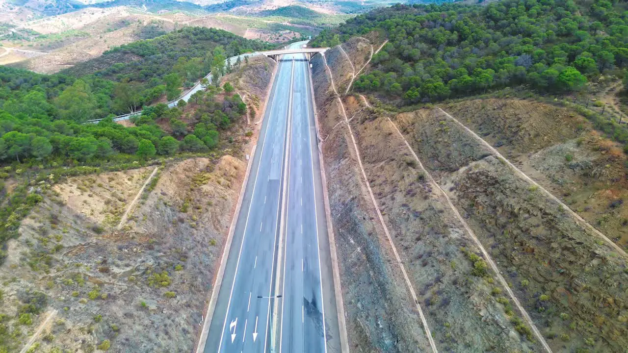 aerial view of lonely highway through rugged landscape 4k