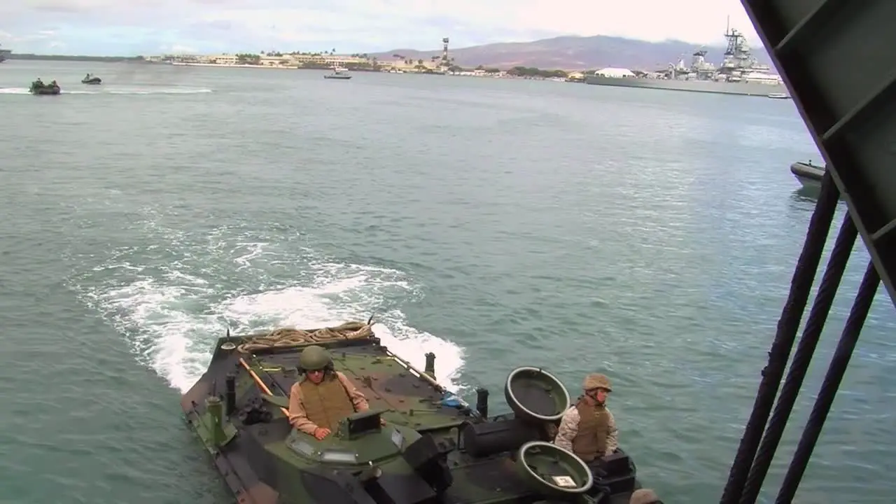 Amphibious Armored Assault Vehicles Are Driven Across A Bay And Onto A Ship 4