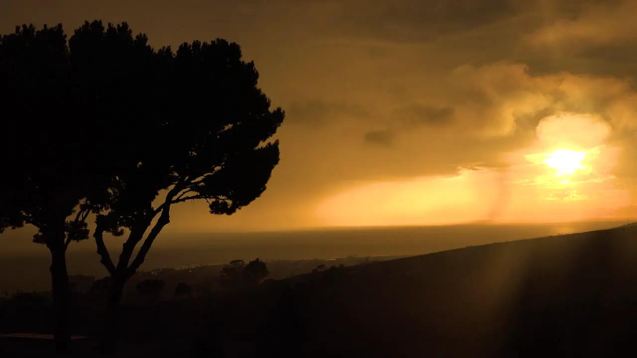 Lightning Strikes Off The Coast Of California During An Electrical Storm With Tree Foreground