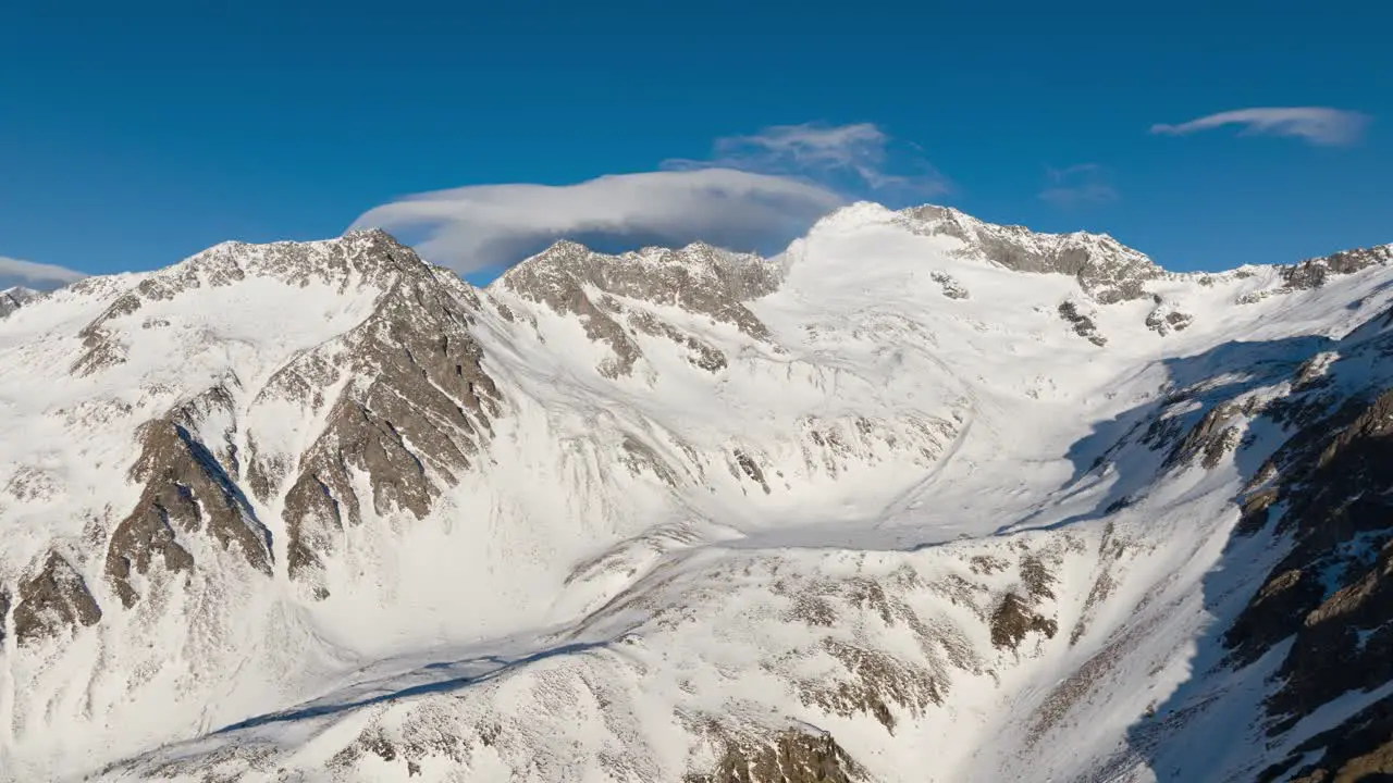 Drone Timelapse of clouds flowing over a mountain range in winter