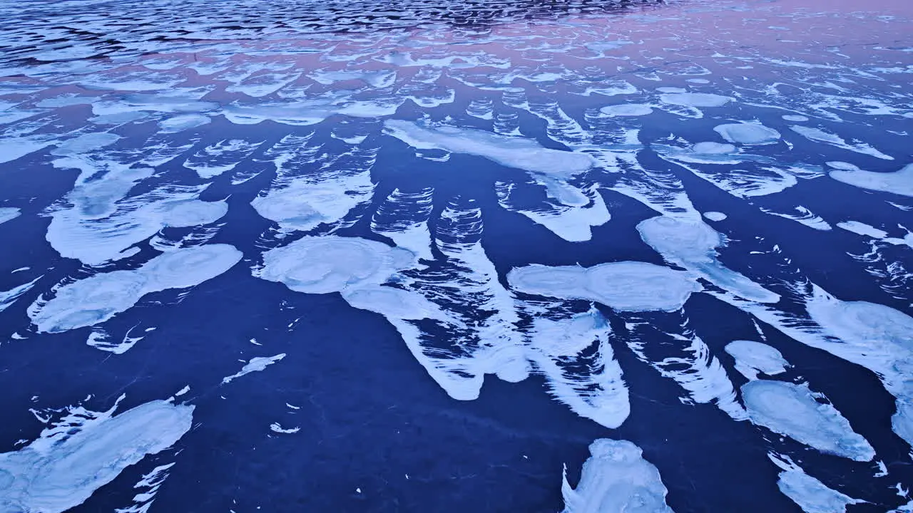 Drone footage showcasing the expansive beauty of ice formations in the water