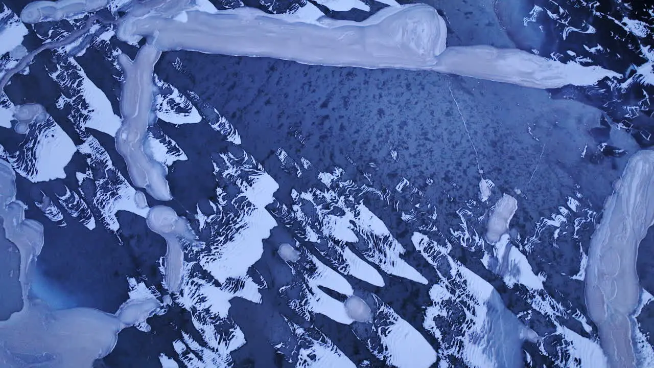 An overhead drone shot reveals massive ice chunks adrift in the water