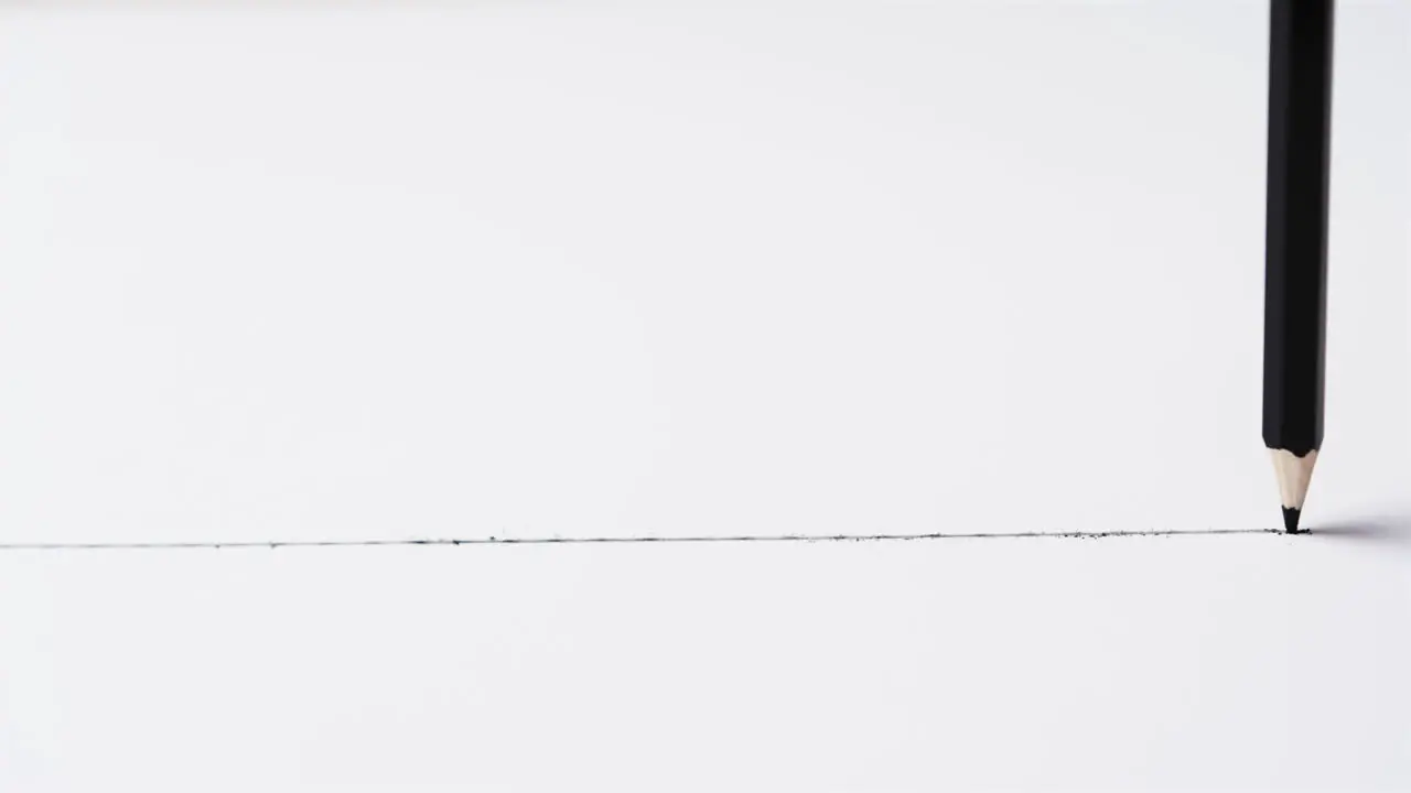 Clouse up of pencil drawing line on white background with copy space in slow motion