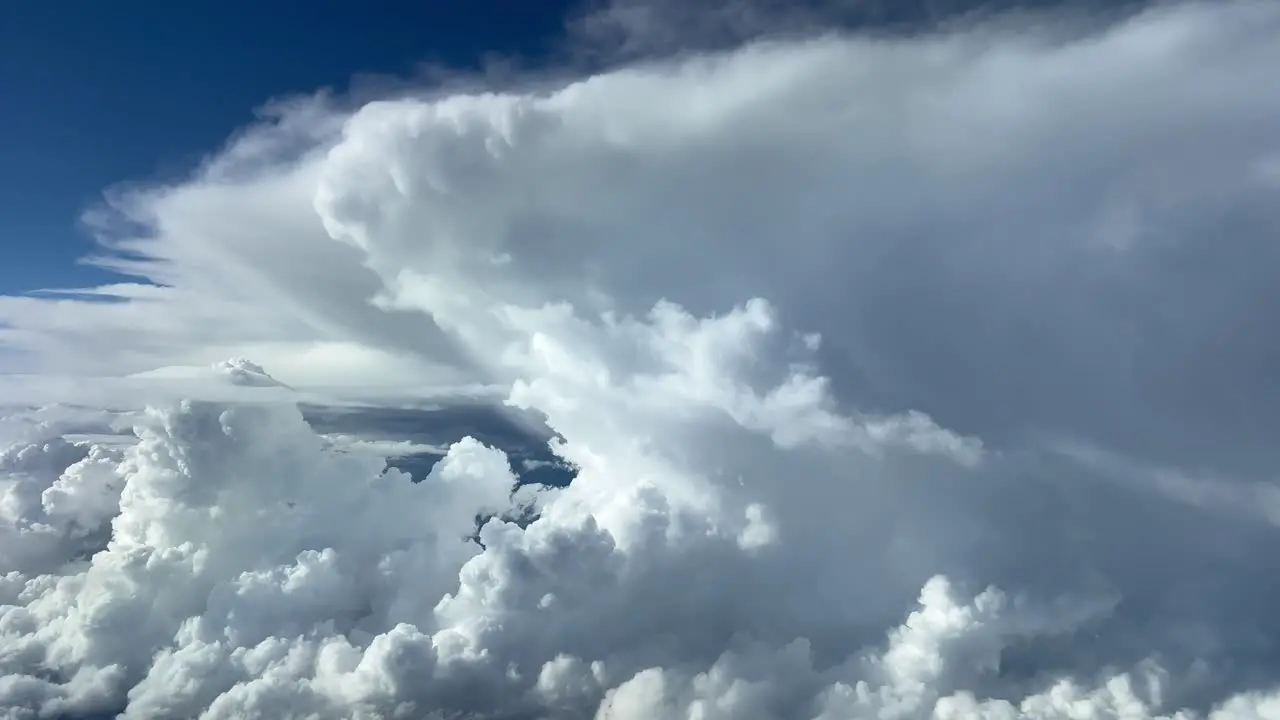 Stunning view of the upper part of a huge cumulonimbus from the cockpit of a jet flying at 12000 metres high