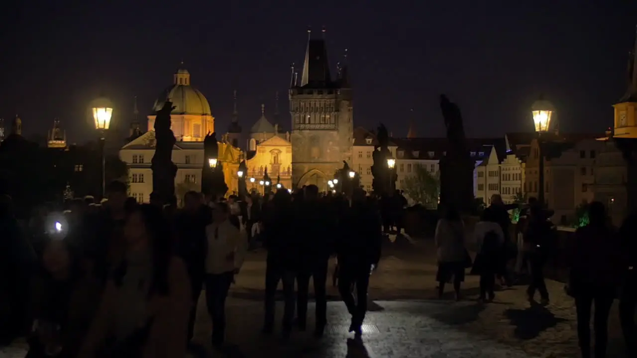 Night view of Charles Bridge with people Prague