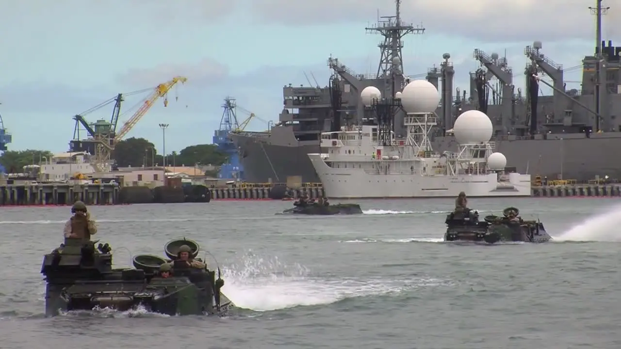 Amphibious Armored Assault Vehicles Are Driven Across A Bay And Onto A Ship 2