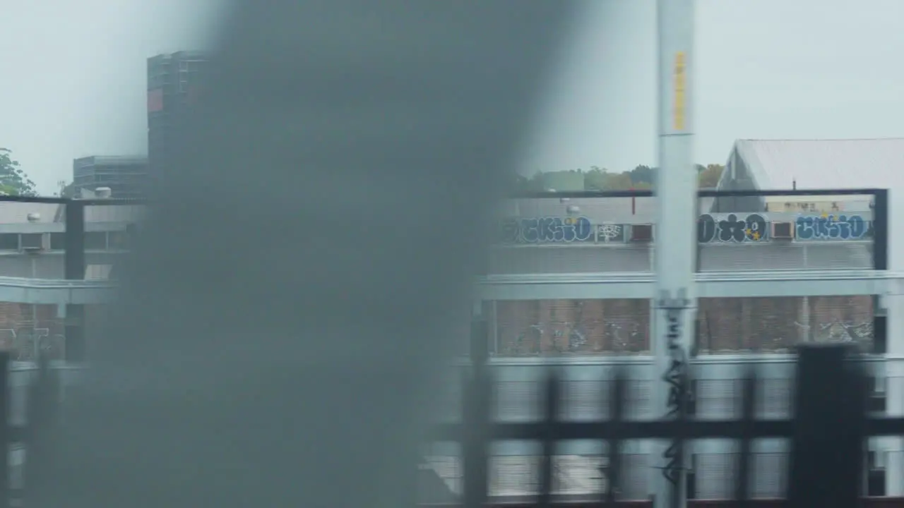 Filming out of a train window during the early dawn passing an industrial estate in Sydney Australia