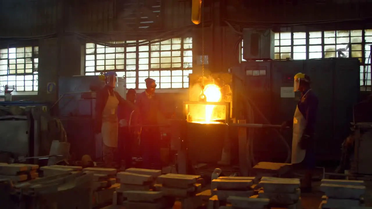 Workers melting metal in foundry workshop 4k