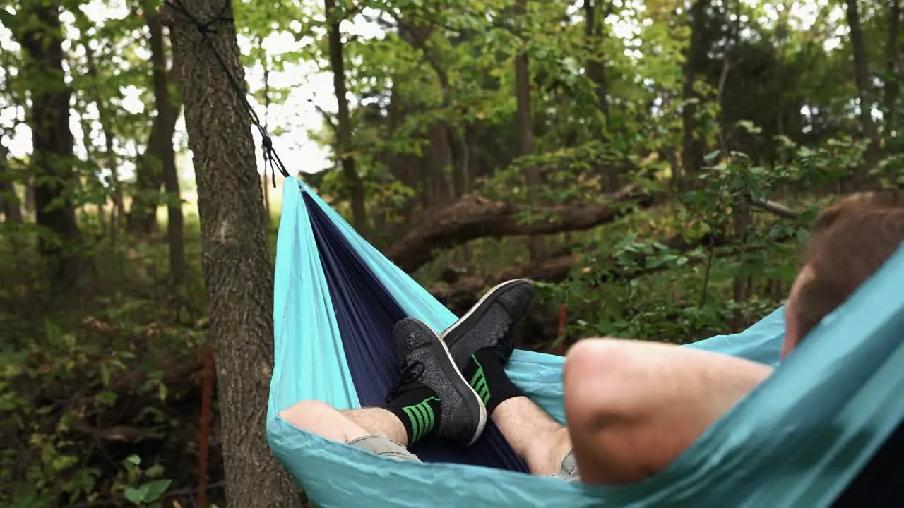 Relaxing in a hammock in the woods during a cool autumn evening