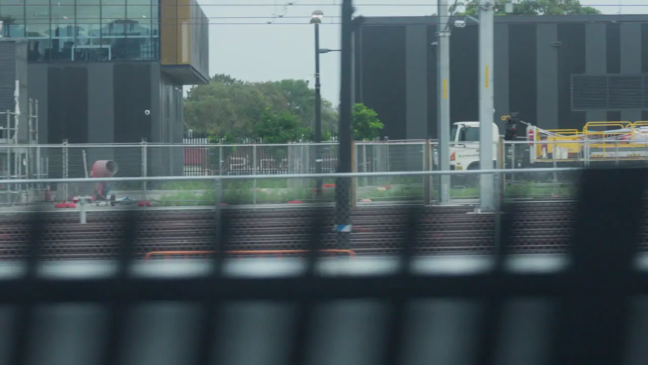 Filming out of a train window during the early dawn passing railway lines and a train yard in Sydney Australia